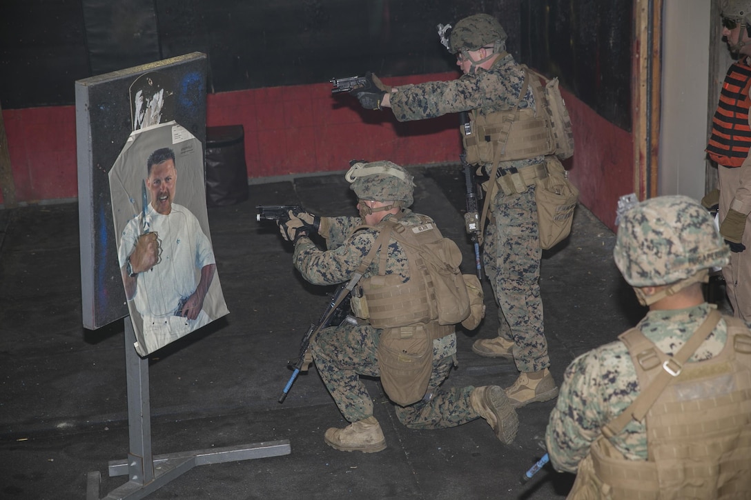 Marines engage an armed objective during a room-clearing exercise at Advanced Interior Tactics training aboard Naval Support Activity Northwest Annex in Chesapeake, Va., Dec. 7. During the course, Marines were taught to identify the hands of an individual to determine whether or not they posed a threat, in order to control the scene and conduct thorough house clearings. (Official U.S. Marine Corps photo by Sgt. Kayla D. Rivera/ Released)