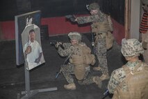 Marines engage an armed objective during a room-clearing exercise at Advanced Interior Tactics training aboard Naval Support Activity Northwest Annex in Chesapeake, Va., Dec. 7. During the course, Marines were taught to identify the hands of an individual to determine whether or not they posed a threat, in order to control the scene and conduct thorough house clearings. (Official U.S. Marine Corps photo by Sgt. Kayla D. Rivera/ Released)