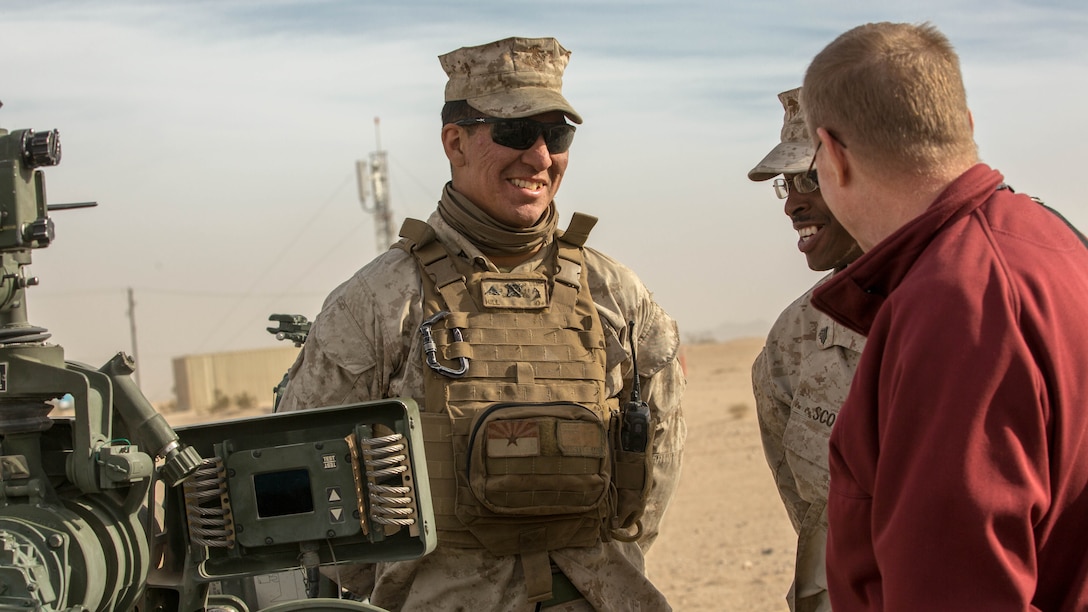 Lance Cpl. Marlon A. Hill, field artillery cannoneer, 3rd Battalion, 11th Marine Regiment, explains different efforts and technologies 3/11 has utilized during the Energy Capability Exercise, in alignment with the Great Green Fleet initiative, at Camp Wilson aboard the Marine Corps Air Ground Combat Center, Twentynine Palms, California, Dec. 6, 2016.