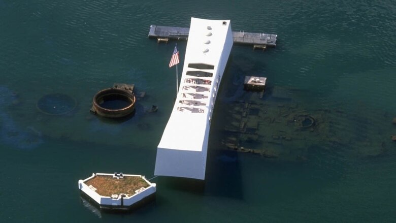 The USS Arizona Memorial, dedicated in 1962, straddles the remains

of the battleship sunk during the surprise Japanese air attack, Dec.

7, 1941. The memorial pays tribute to the nearly 1,200 sailors and

Marines who died aboard the Pennsylvania-class super-dreadnaught

during the attack as well as all of the 2,403 military and civilian

personnel who perished that Sunday morning. A bomb detonated in

her powder magazine caused a violent explosion and immediately

sank the craft, Navy hull number BB-39.The more than one million

visitors a year to the memorial can see the diesel fuel leaking from the

submerged wreck to this day.
