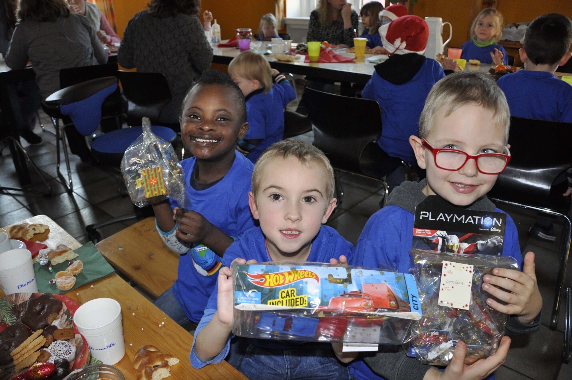 Children of the Bitburg Saint Martin school show off their presents they received by members of the 52nd Civil Engineer Squadron during the school‘s annual Saint Nicholas celebration, Dec. 5 in Bitburg. The event included a visit by Saint Nicholas, dances and singing performances by the children, as well as a gift presentation by the 52nd Fighter Wing. The celebration was attended by Saint Martin school officials, parents, 52nd Fighter Wing leadership spouses, as well as Airmen and civilians from the wing, who provided gifts to students and kindergarten children. In the summer,  Spangdahlem Sabers invited the Saint Martin school to Special Children’s Day at Spangdahlem AB, where they played games and spent a fun-filled time together. (U.S. Air Force photo by Iris Reiff)