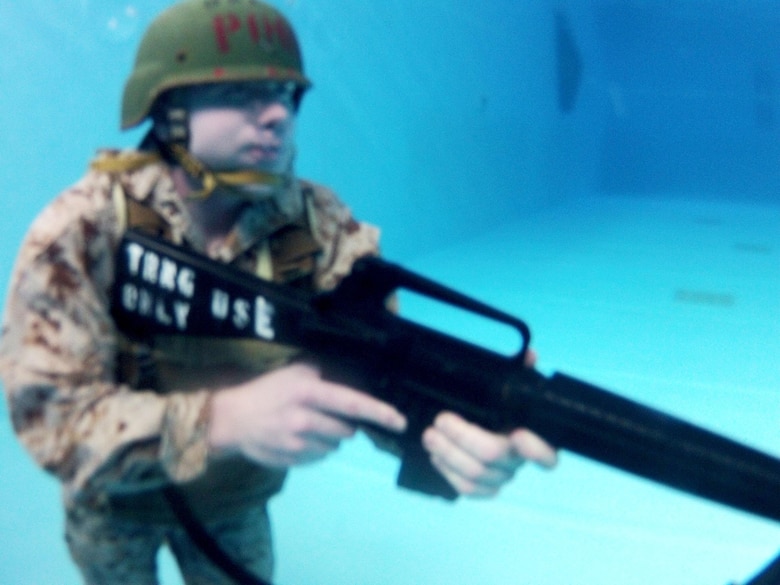 Cpl. Aaron Rayburn is submerged in a pool with combat gear at Marine Corps Air Station Cherry Point, N.C., Oct. 25, 2016. Rayburn, originally an air framer with Marine Transport Squadron 1, volunteered to become a search and rescue swimmer with the squadron. After the search and rescue mission for VMR-1 ended, he took his aquatic skills and applied them as a Marine Combat Instructor of Water Survival. Rayburn is a MCIWS with VMR-1. (U.S. Marine Corps photo by Cpl. Jason Jimenez/Released)