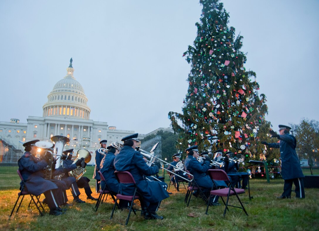 Capt. Dustin Doyle (right), U.S. Air Force Ceremonial Brass Band flight commander, conducts the band during the U.S. Capitol Christmas Tree Lighting Ceremony on the Capitol’s West Front Lawn in Washington D.C., Dec. 6, 2016. By performing Christmas classic standards during the ceremony, the band accomplishes its mission to inspire American citizens to heightened patriotism. 