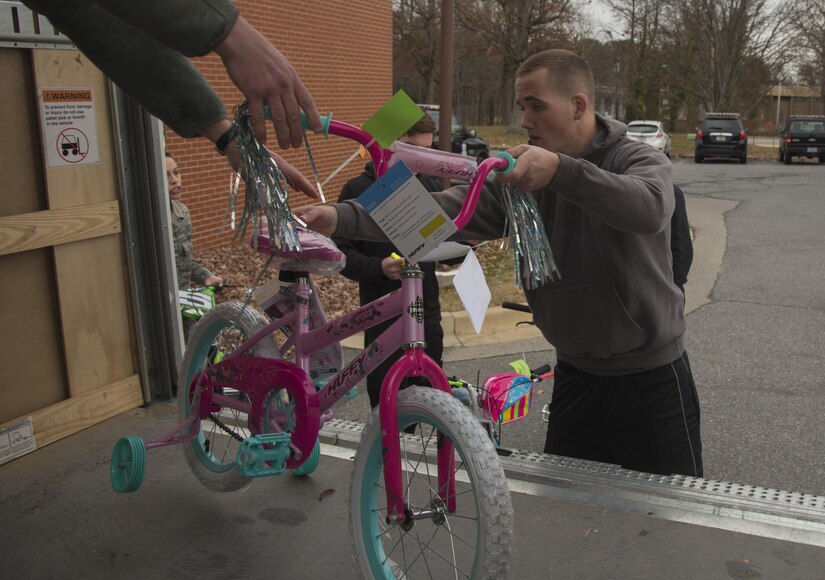 Airman 1st Class Kyle Plotzer, 811th Security Forces Squadron executive aircraft security, loads a storage truck with bicycles for the Salvation Army Angel Tree Program on Joint Base Andrews, Md., Dec. 8, 2016. Gifts were donated to the program for children of the less fortunate during the holidays. (U.S. Air Force photo by Airman 1st Class Valentina Lopez)