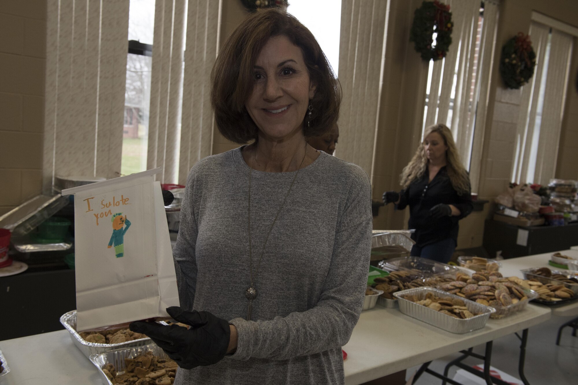 Sue Fleming, a seven-time volunteer at the annual event, displays some holiday cheer on one of the cookie bags at the cookie drive at Joint Base McGuire-Dix-Lakehurst, New Jersey, Dec. 8, 2016. Local schools, military spouses and community members donated cookies and their time to organize the program that delivers cookies to junior enlisted service members across the joint base. 