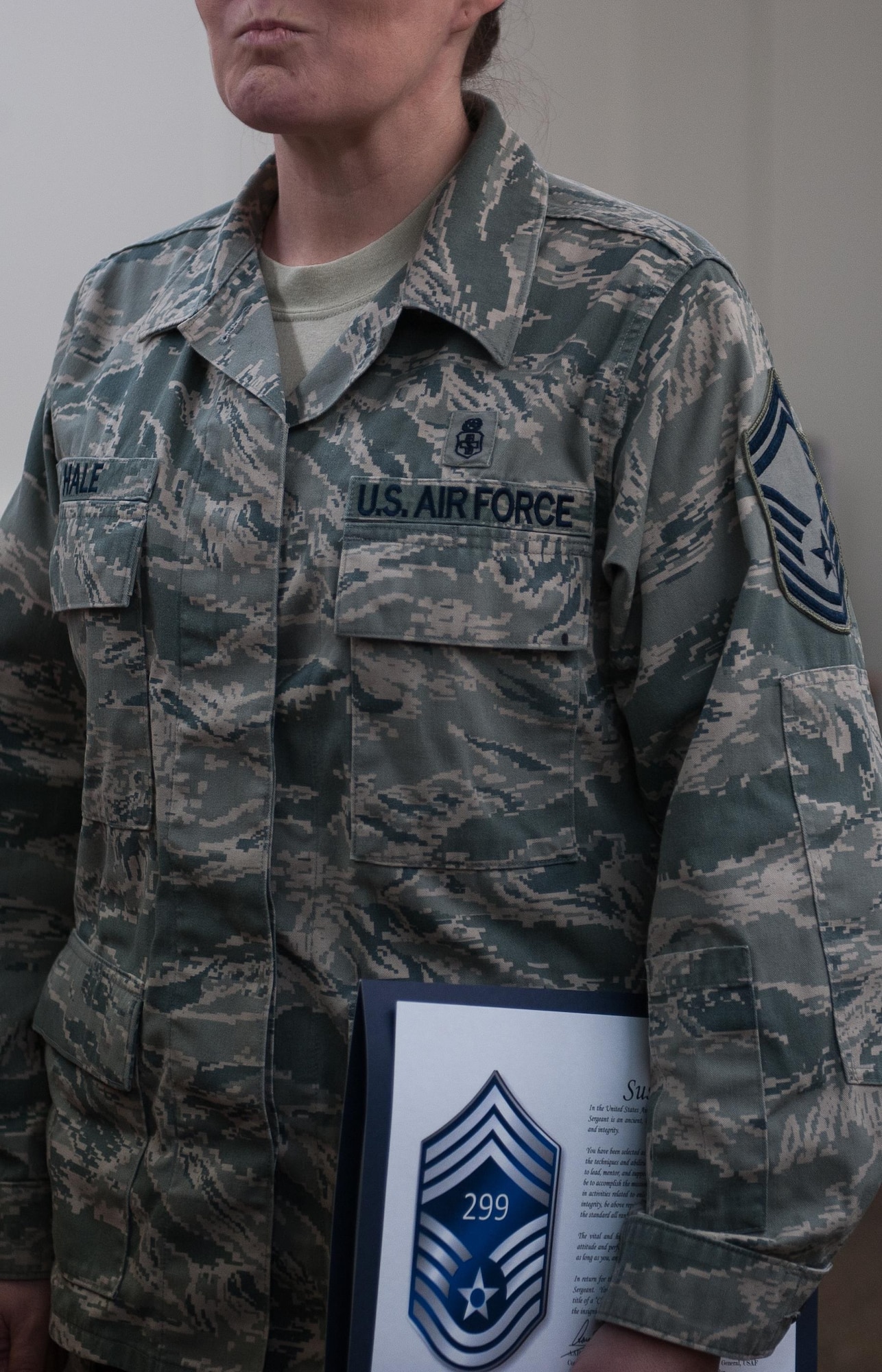 Senior Master Sgt. Susan Hale, 86th Medical Squadron command support section operations superintendent, stands with her notification of her promotion to chief master sergeant at Landstuhl Regional Medical Facility, Germany, Dec. 8, 2016. Leaders across Ramstein Air Base joined the selectees to not only congratulate, but also to educate them on the tasks and responsibilities ahead. (U.S. Air Force photo by Airman 1st Class Lane T. Plummer)