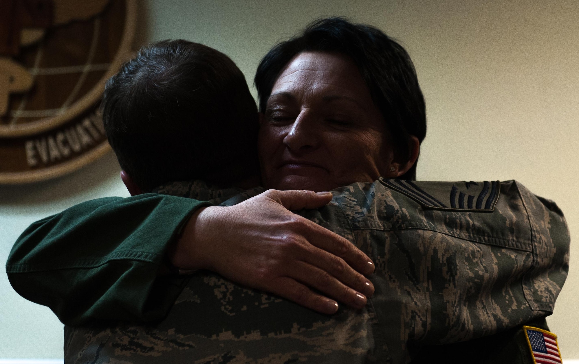 Senior Master Sgt. Mellisa Crawley, 86th Aeromedical Evacuation Squadron superintendent, embraces her husband, Chief Master Sgt. Michael Crawley, 86th Force Support Squadron superintendent, after being notified of her promotion to chief master sergeant at Ramstein Air Base, Germany, Dec. 8, 2016. After discovering they were selected for promotion, all selectees came together and celebrated, as well as built more relationships with people across the community. (U.S. Air Force photo by Airman 1st Class Lane T. Plummer)