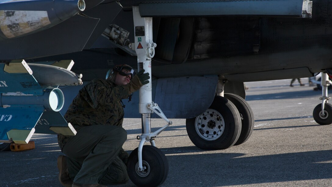 U.S. Marine Corps Lance Cpl. Breht Urzua, a power line technician with Marine Attack Squadron 542, conducts a routine inspection of an AV-8B Harrier prior to flight at Chitose Air Base, Japan, Dec. 7, 2016. During the ATR the Marines with the power line division for VMA-542 have ensured the safety of all aircraft involved through routine flight inspections, launching the aircraft and recovering the aircraft. 