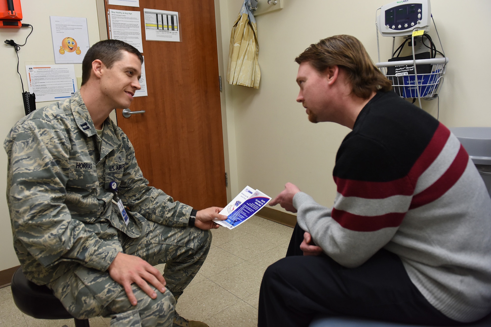 Capt. Stephen Horras, 341st Medical Operations Squadron physician, discusses the benefits of using Tricare Online with a patient, Dec. 8, 2016.  Tricare Online is a web portal that allows patients to take care of their medical needs such as make appointments, look at their health record and send direct messages to their health care provider while online.  (U.S. Air Force photo/Jason Heavner)