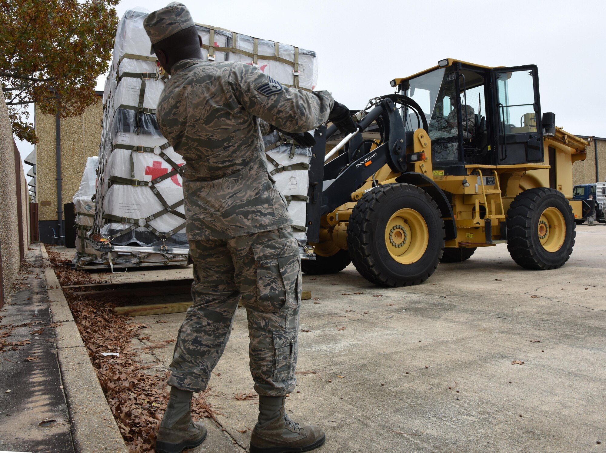 Staff Sgt. Junior Avilma, 81st Logistics Readiness Squadron vehicle operator, guides Airman 1st Class David Whatley, 81st LRS vehicle maintainer, as he transports cargo at the supply warehouse loading docks during a deployment exercise Dec. 7, 2016, on Keesler Air Force Base, Miss. The exercise scenario tested the mission readiness of Team Keesler for simultaneous world-wide deployments. (U.S. Air Force photo by Kemberly Groue)