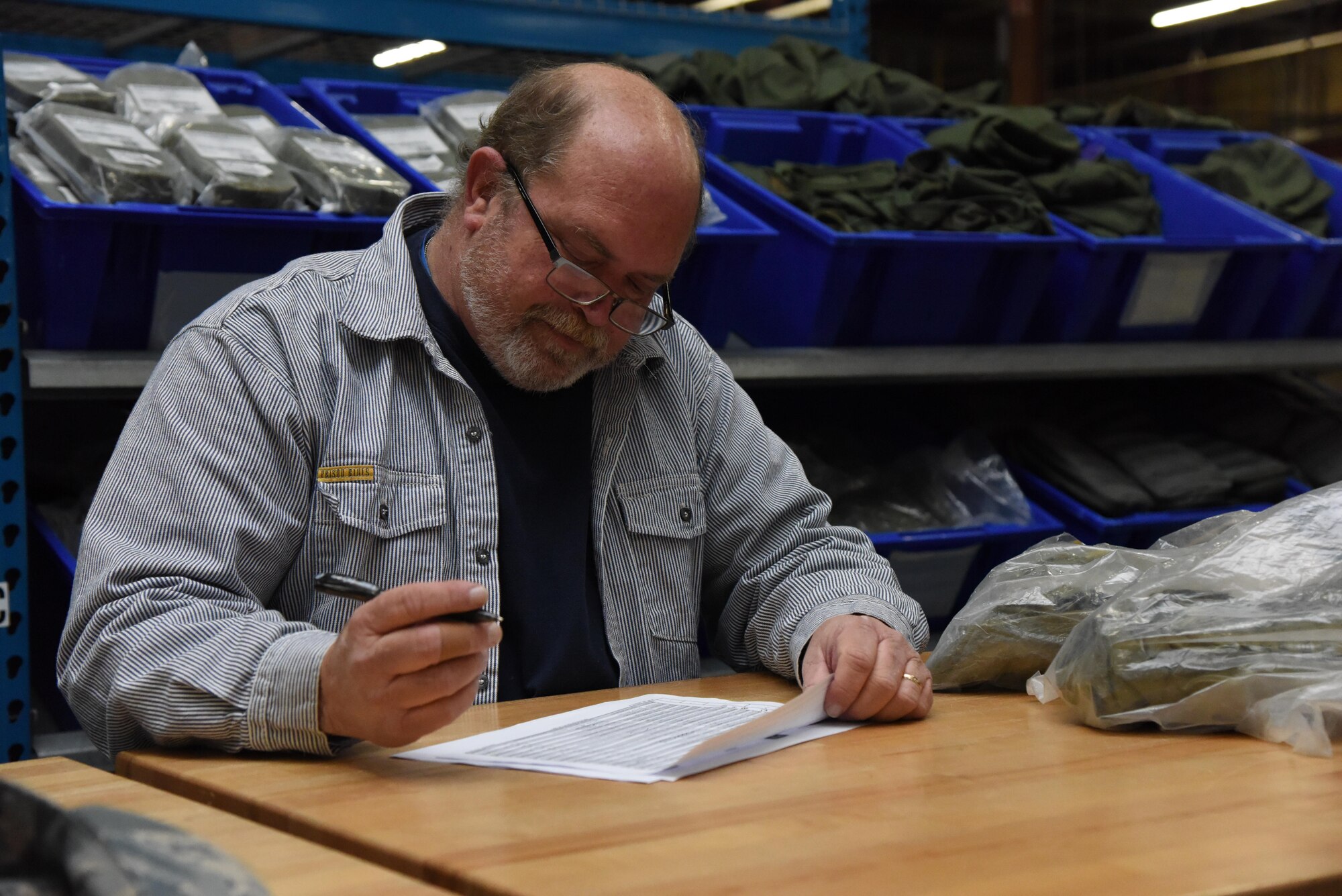 Ron Hartley, Base Operations Support supply technician, issues mobility bag items at the supply warehouse during a deployment exercise Dec. 8, 2016, on Keesler Air Force Base, Miss. The exercise scenario tested the mission readiness of Team Keesler for simultaneous world-wide deployments. (U.S. Air Force photo by Kemberly Groue)