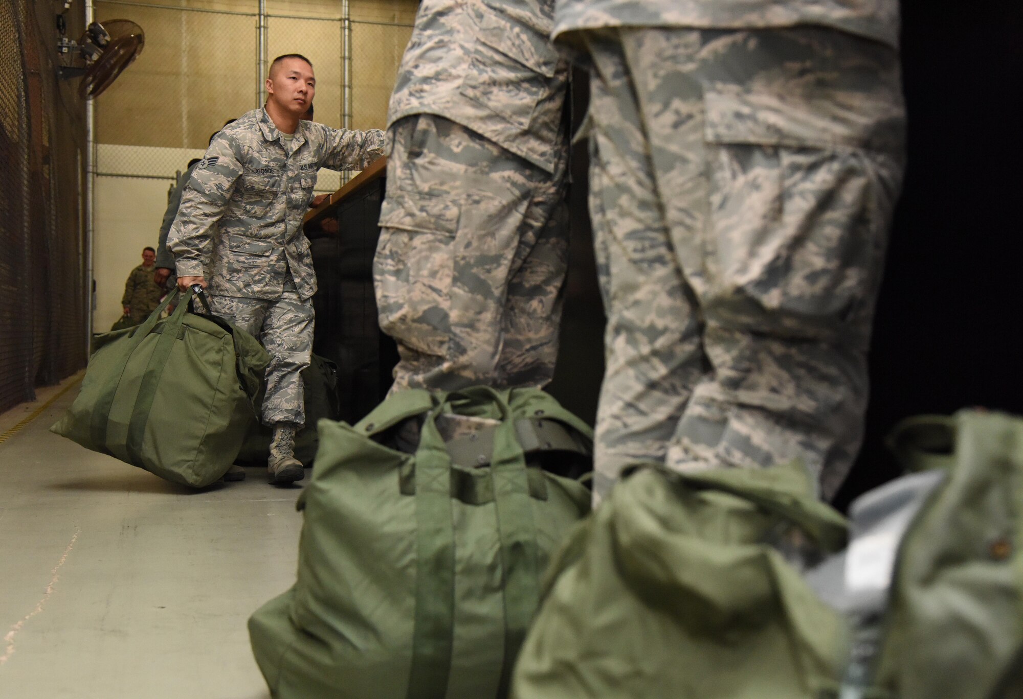 Senior Airman Xeng Xiong, 81st Force Support Squadron technician, receives mobility bag items at the supply warehouse during a deployment exercise Dec. 8, 2016, on Keesler Air Force Base, Miss. The exercise scenario tested the mission readiness of Team Keesler for simultaneous world-wide deployments. (U.S. Air Force photo by Kemberly Groue)