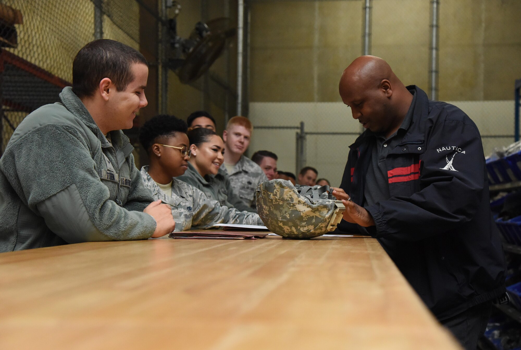 Airman 1st Class John Steen, 81st Logistics Readiness Squadron vehicle operator, receives his mobility bag items from Roderick Harris, Base Operations Support supply technician, at the supply warehouse during a deployment exercise Dec. 8, 2016, on Keesler Air Force Base, Miss. The exercise scenario tested the mission readiness of Team Keesler for simultaneous world-wide deployments. (U.S. Air Force photo by Kemberly Groue)
