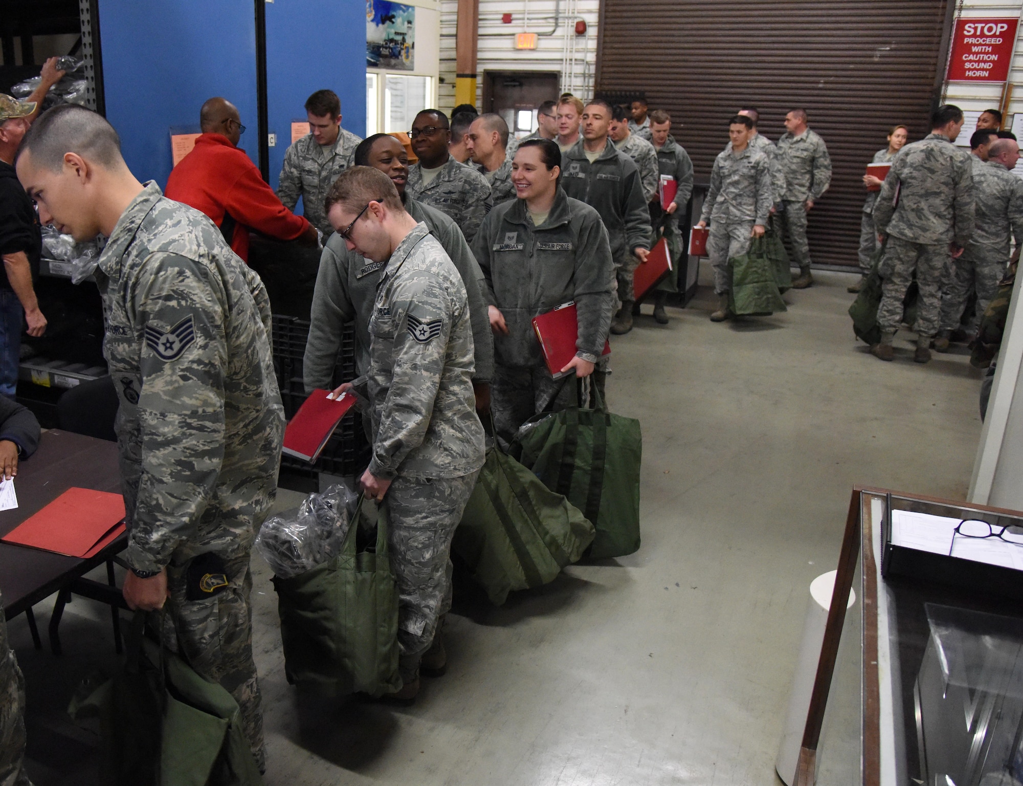 Keesler personnel receive mobility bag items at the supply warehouse during a deployment exercise Dec. 8, 2016, on Keesler Air Force Base, Miss. The exercise scenario tested the mission readiness of Team Keesler for simultaneous world-wide deployments. (U.S. Air Force photo by Kemberly Groue)