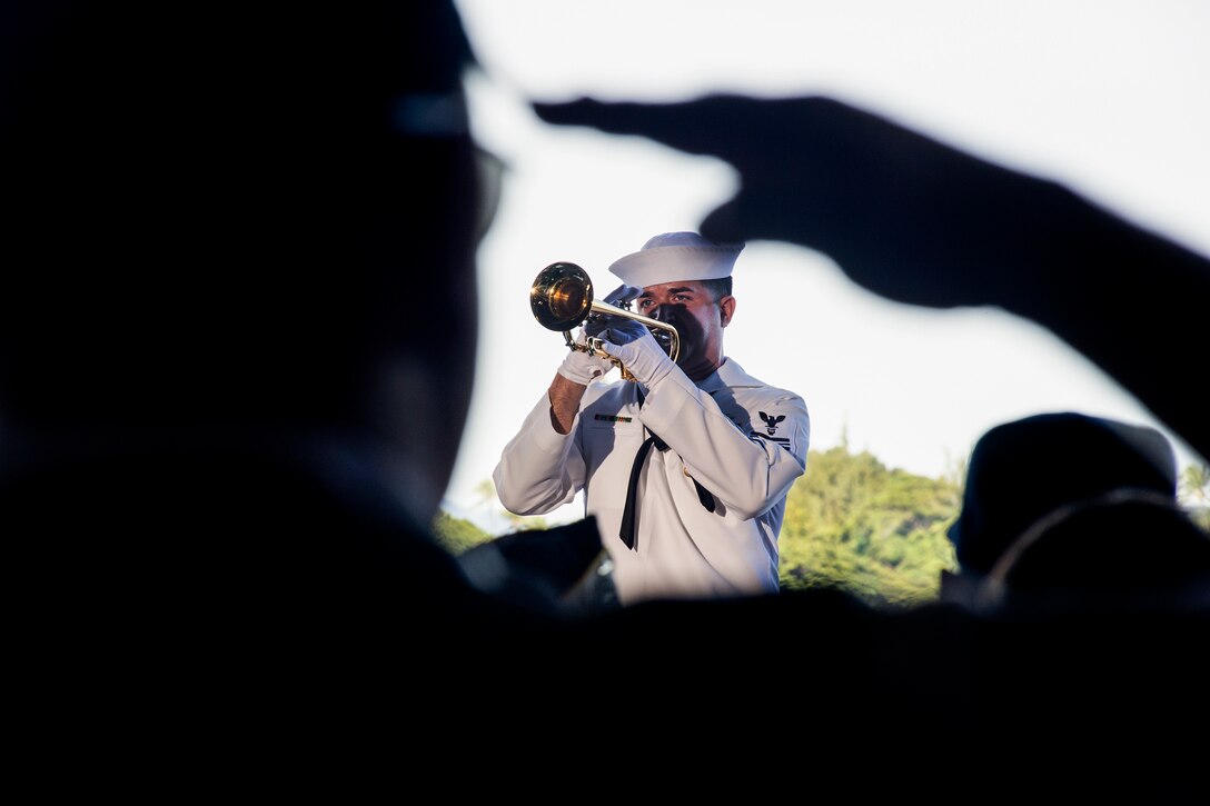 Navy Petty Officer 1st Class Brandon Barbee performs taps during a 75th commemoration event of the attacks on Pearl Harbor at Joint Base Pearl Harbor-Hickam, Hawaii, Dec. 7, 2016. The U.S. military co-hosed the event, which provided veterans, service members and the community a chance to honor the sacrifices made by those who were present during the attacks. Barbee is assigned to the U.S. Pacific Fleet Band. Navy photo by Petty Officer 2nd Class Laurie Dexter