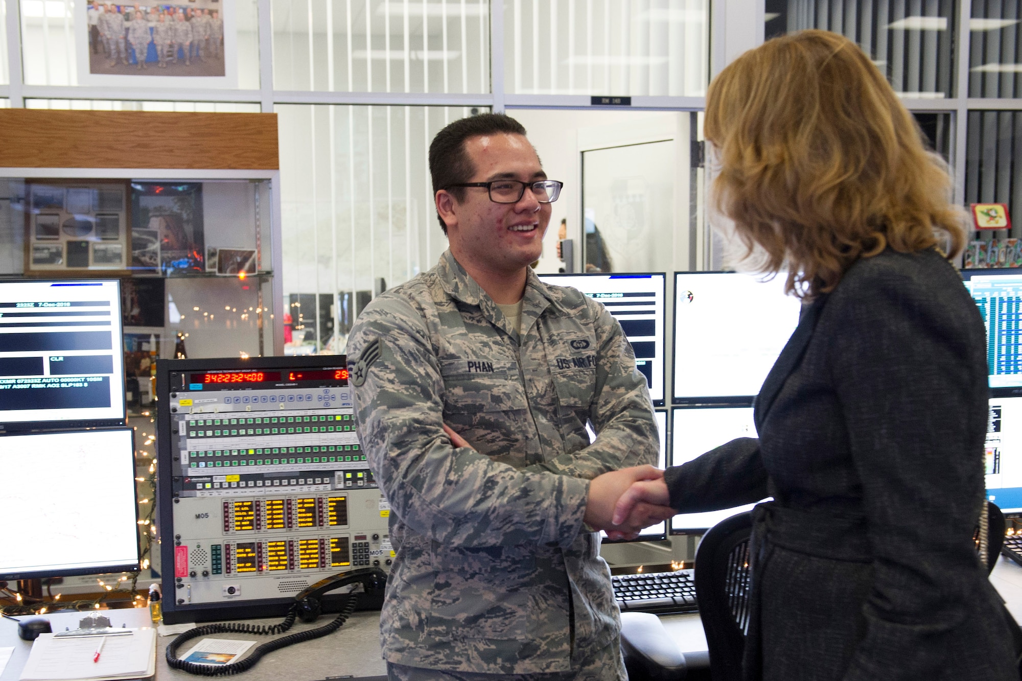 Under Secretary of the Air Force Lisa S. Disbrow coins Senior Airman Phi Phan for his dedication to the weather mission Dec. 7, 2016, at Cape Canaveral Air Force Station, Fla. The 45th Weather Squadron provides operational support to the range to ensure safe access to air and space.
