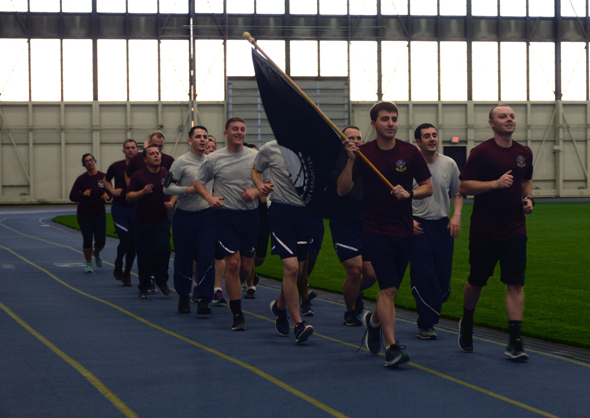 Members from the 28th Contracting and Comptroller Squadrons participate in the second annual Prisoner of War/Missing in Action 24-hour run at Ellsworth Air Force Base, S.D., Dec. 6 to 7, 2016. Participants ran in 30 minute shifts while carrying the POW/MIA flag as a way to honor and remember those who did not make it home. (U.S. Air Force photo by Airman 1st Class Denise M. Jenson)
