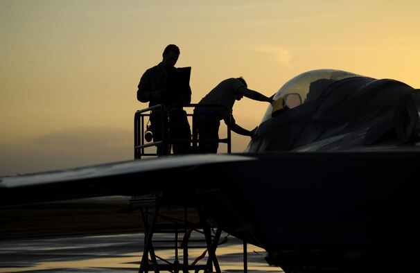 Air Force maintainers from the 325th Maintenance Squadron inspect and wipe off the cockpit of an F-22 Raptor on the flightline at Tyndall Air Force Base, Fla., after a thunderstorm Dec. 5, 2016. The F-22 and other aircraft continued operations after the storm during Checkered Flag 17-1. (U.S. Air Force photo/Senior Airman Solomon Cook)