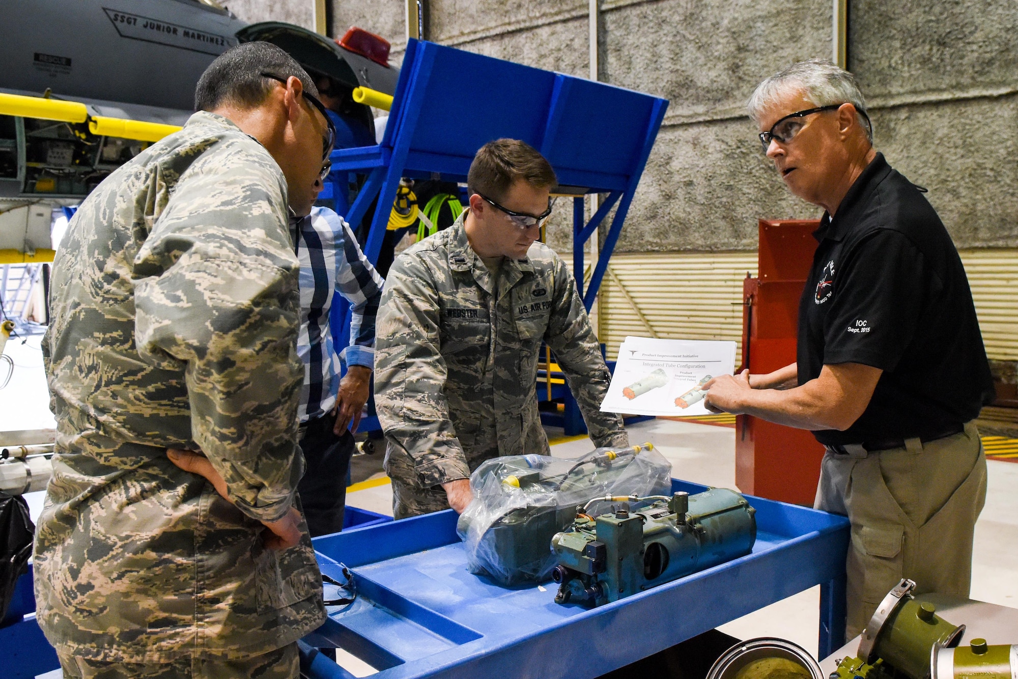 Kevin Kelly (right), Boeing Co. Radar Modernization Program integrator, shows the group a liquid cooling pump from the F-15E Strike Eagle, Oct. 3, 2016, at Seymour Johnson Air Force Base, North Carolina. Boeing Co. is contracted to install the upgrade of a new radar system from the old legacy APG-70 mechanically-scanned radar to an active electronically-scanned radar system APG-82. (U.S. Air Force photo by Airman Shawna L. Keyes)