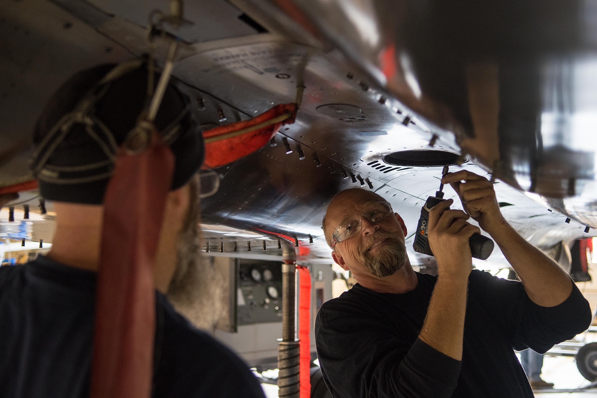 Charles Loy (right), Boeing Co. aircraft mechanic, begins to remove a panel off an F-15E Strike Eagle, Nov. 1, 2016, at Seymour Johnson Air Force Base, North Carolina. The F-15E is receiving a Radar Modernization program; it’s first major upgrade of its radar system in more than 20 years. (U.S. Air Force photo by Airman Shawna L. Keyes)