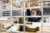 Brian Petticoffer, Boeing Co. aircraft mechanic and member of the Radar Modernization Program Eagle modernization program team, closes a supply cage, Nov. 1, 2016, at Seymour Johnson Air Force Base, North Carolina. The RMP team at Seymour Johnson AFB is comprised of avionic technicians, E&E, and general mechanics that are a part of installing the upgraded radar system, APG-82, into the aircrafts. (U.S. Air Force photo by Airman Shawna L. Keyes)