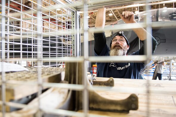 Brian Petticoffer, Boeing Co. aircraft mechanic and member of the Radar Modernization Program Eagle modernization program team, closes a supply cage, Nov. 1, 2016, at Seymour Johnson Air Force Base, North Carolina. The RMP team at Seymour Johnson AFB is comprised of avionic technicians, E&E, and general mechanics that are a part of installing the upgraded radar system, APG-82, into the aircrafts. (U.S. Air Force photo by Airman Shawna L. Keyes)
