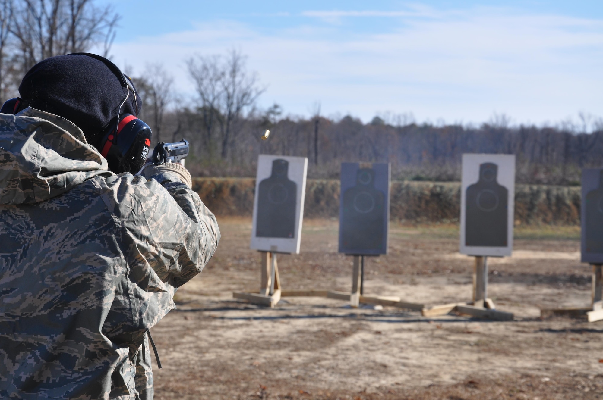 A member of the 459th Security Forces Squadron fires an M9 handgun at a target at Marine Corps Base Quantico, Virginia, firing range Dec. 3, 2016. More than 150 459th SFS members traveled from Joint Base Andrews, Maryland, to Quantico to train on the M4 assault rifle and M9 handgun. (U.S. Air Force photo/Senior Airman Kristin Kurtz)