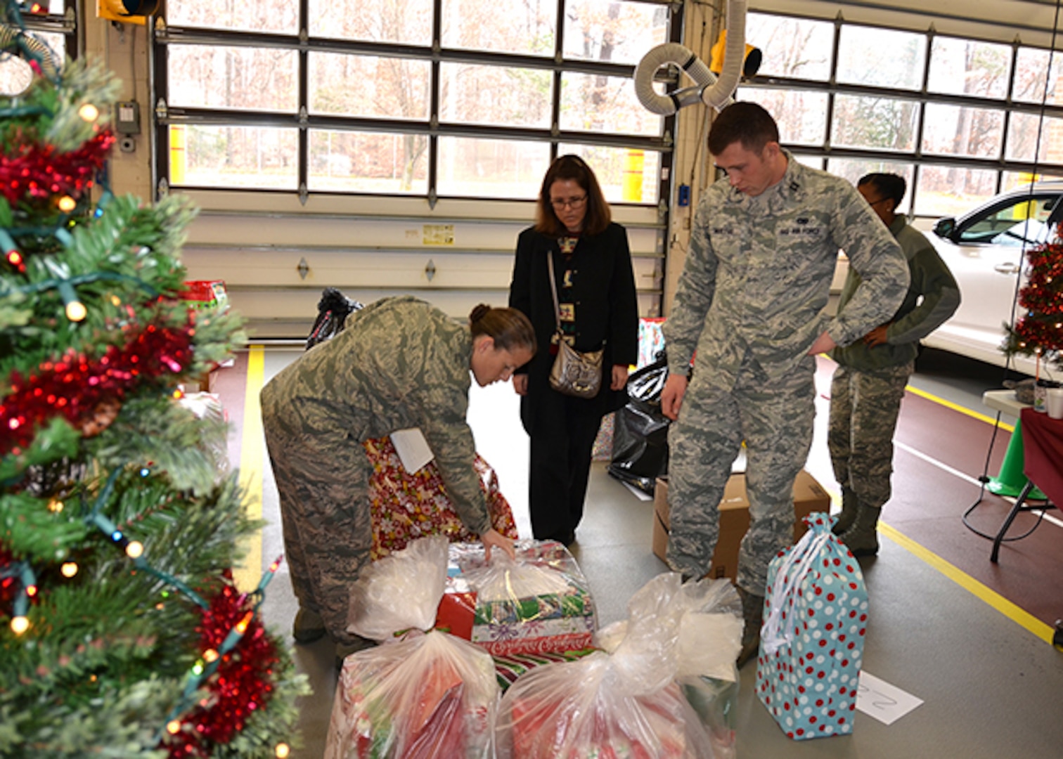 Defense Logistics Agency Aviation’s military personnel help check off Angel Tree gifts with Kim Forquer, a guidance couns3elor from Meadowbrook High School during gift pickup Dec. 8, 2016 at Defense Supply Center Richmond, Virginia’s fire station.  Employees adopted 113 angels from Chesterfield County and Richmond City Public Schools.