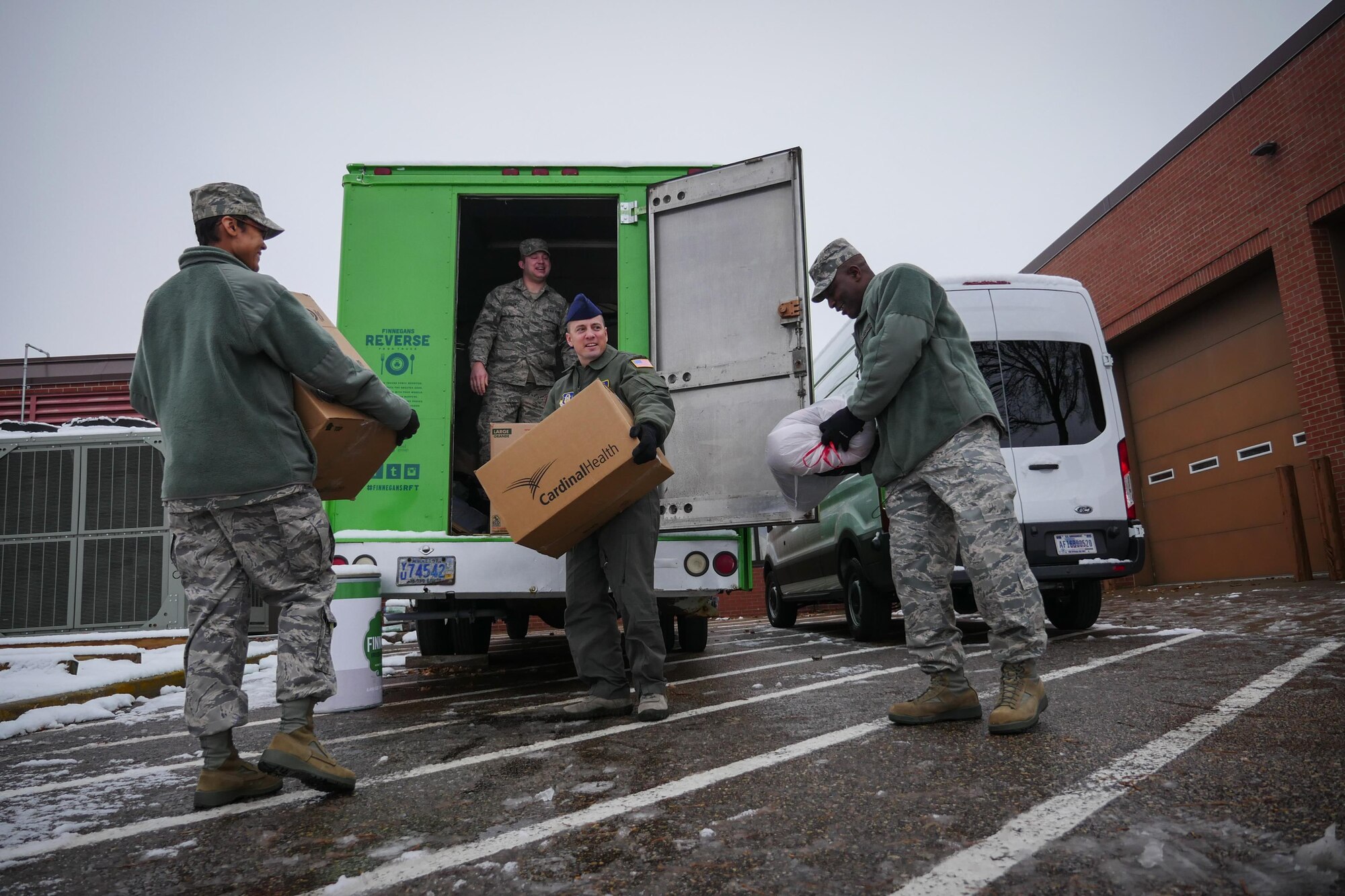 Airmen assigned to the 934th Aeromedical Staging Squadron help load a truck with donated clothing for homeless veterans during the December Unit Training Assembly at the Minneapolis-St. Paul Air Reserve Station, Minn. (U.S. Air Force photo by Staff Sgt. Corban D. Lundborg/Released)