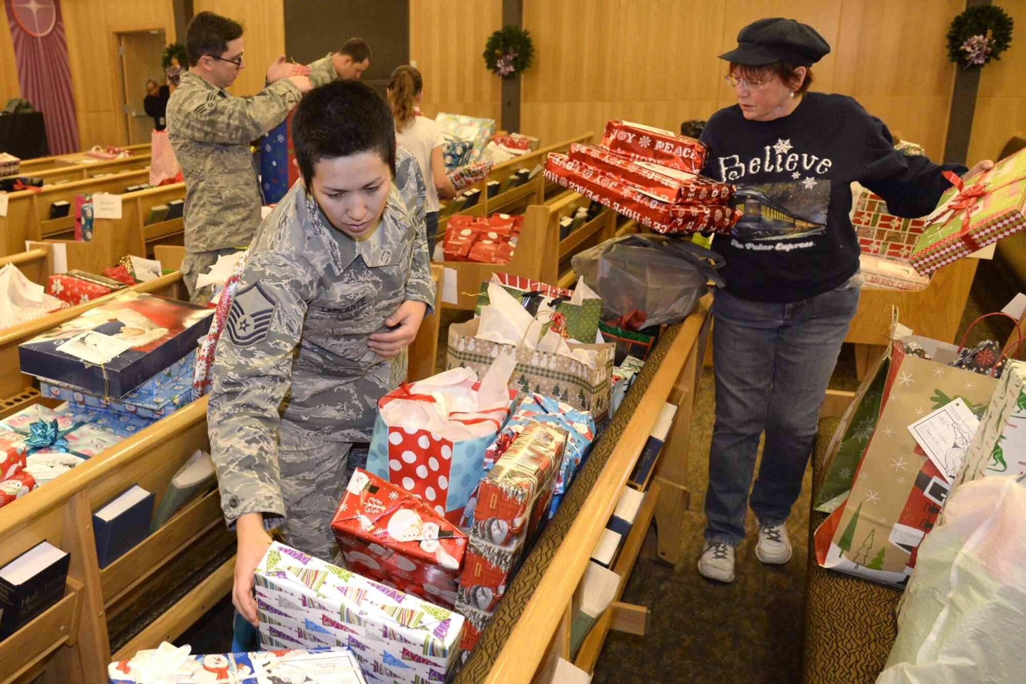 Master Sgt. Jennifer Laplante, 75th Dental Squadron, and Marjorie Cremer, volunteer, sort gifts Dec. 7 at the Hill AFB Chapel for the annual Angel Tree program. Volunteers organized donated gifts for distribution to military families. (U.S. Air Force photo by Todd Cromar)
