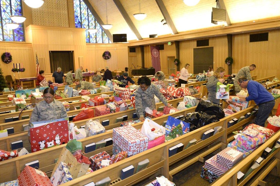 Team Hill volunteers sort gifts Dec. 7 at the Hill AFB Chapel for the annual Angel Tree program. Volunteers organized donated gifts for distribution to military families. (U.S. Air Force photo by Todd Cromar)