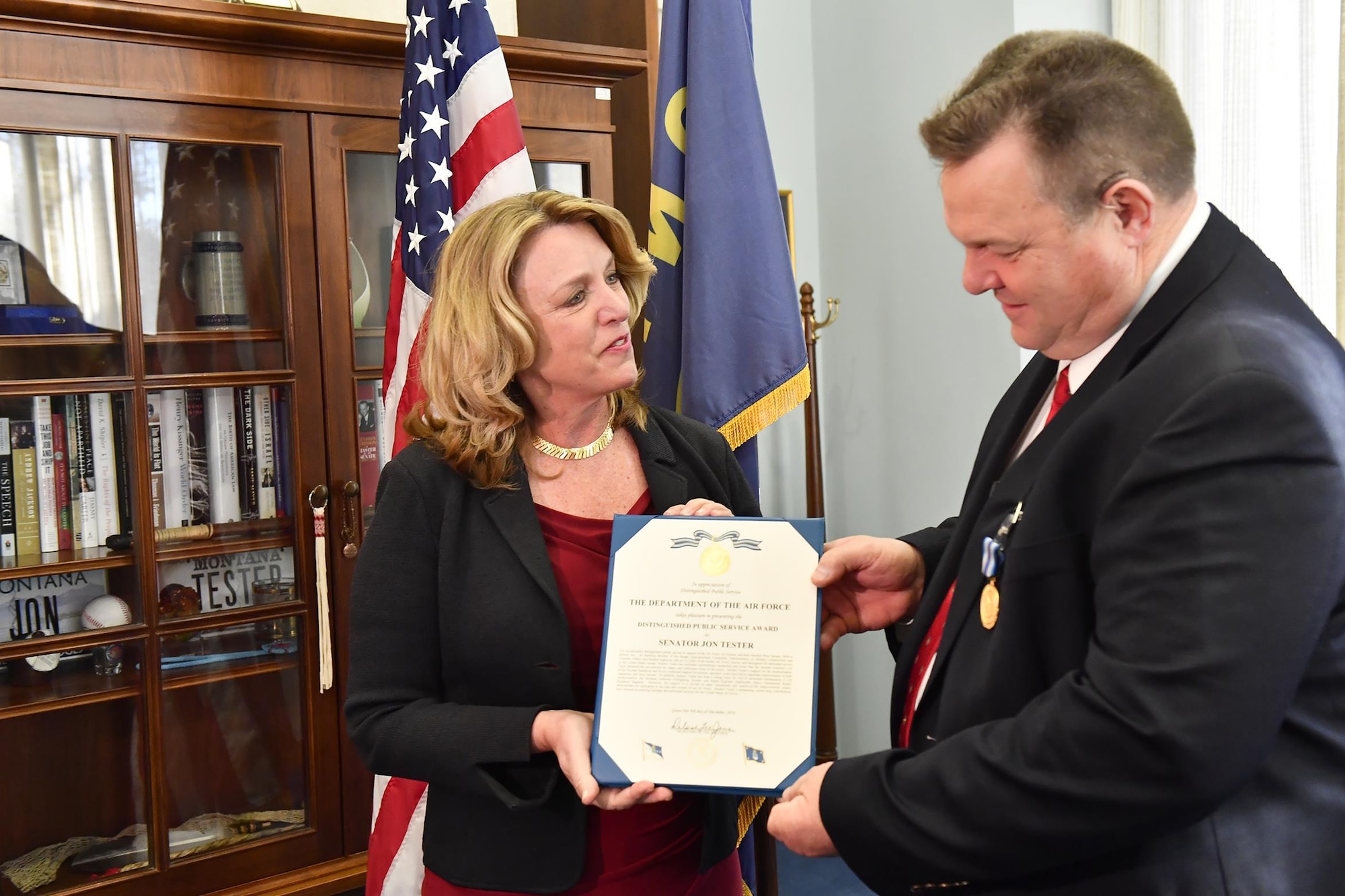 Air Force Secretary Deborah Lee James presents the Distinguished Public Service Award to U.S. Rep. Jon Tester (D-Mont.), Dec. 9, 2016, in Washington, D.C. Tester was also a strong voice for UH-1N helicopter replacement, C-130 Hercules modernization, the Modular Airborne Firefighting System, and Rapid Engineer Deployable Heavy Operational Repair Squadron Engineer.(U.S. Air Force photo/Scott M. Ash)