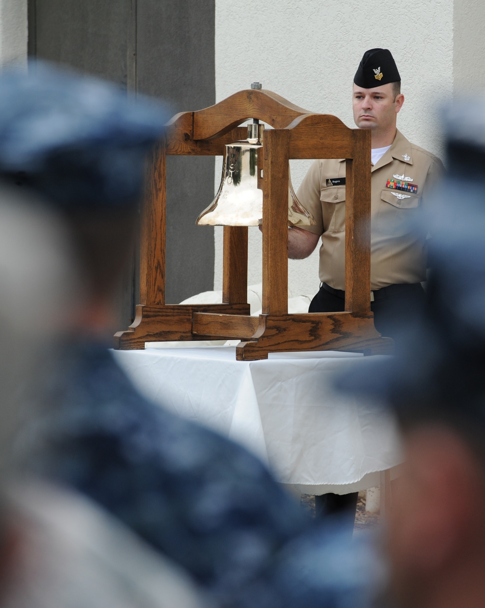U.S. Navy Petty Officer 1st Class James Rogers, Center for Naval Aviation Technical Training Unit Keesler instructor, rings a bell in memory of every ship destroyed during the attacks on Pearl Harbor at a CNATTU Keesler Pearl Harbor 75th Anniversary Remembrance Ceremony in front of Allee Hall Dec. 7, 2016, on Keesler Air Force Base, Miss. More than 100 Keesler personnel attended the event to honor those lost in the Dec. 7, 1941 Pearl Harbor attacks. (U.S. Air Force photo by Kemberly Groue)