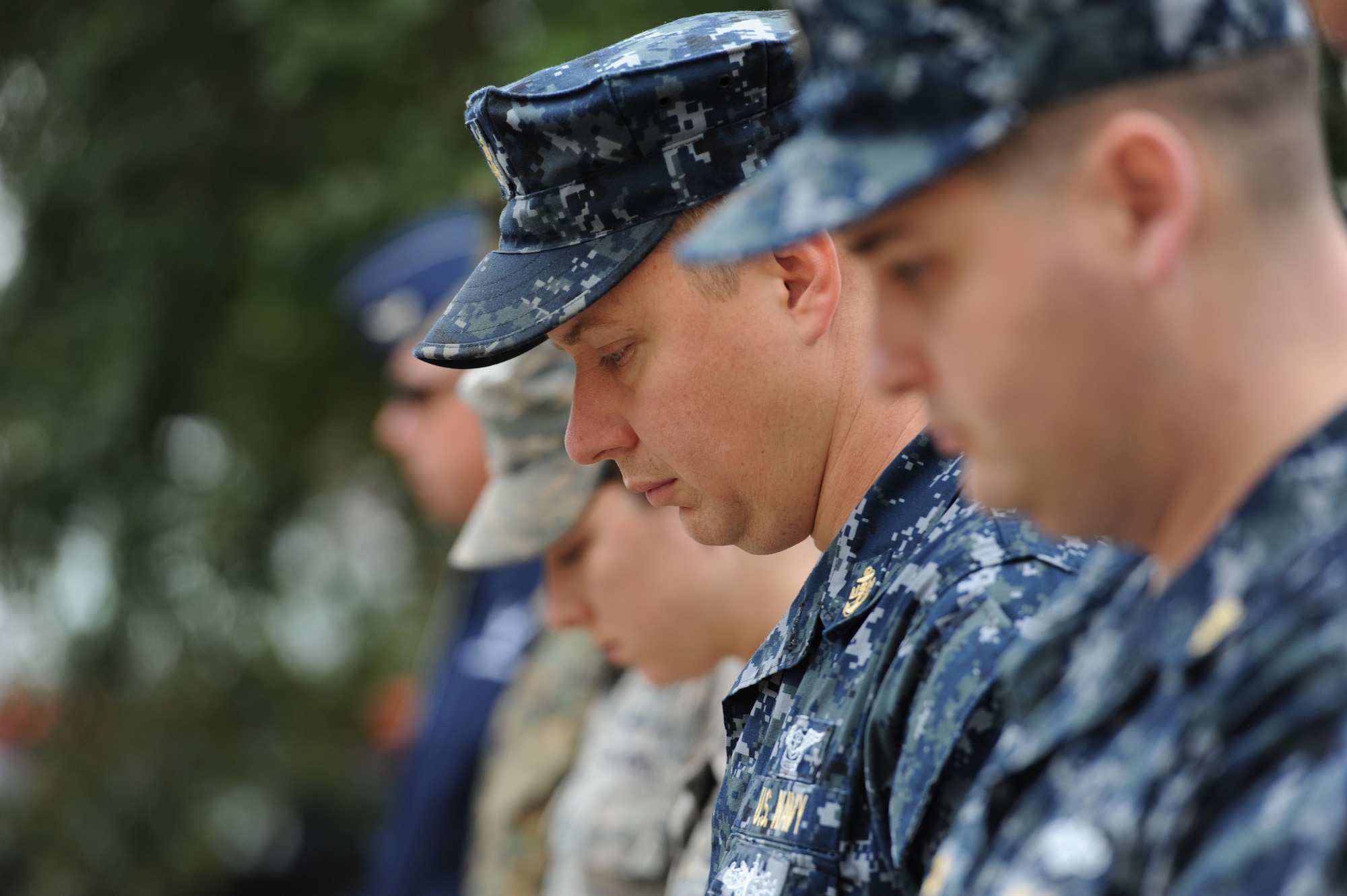 U.S. Navy Chief Petty Officer Brant Pendleton, Center for Naval Aviation Technical Training Unit Keesler curriculum and instructional standards officerpauses for a moment of silence during a CNATTU Keesler Pearl Harbor 75th Anniversary Remembrance Ceremony in front of Allee Hall Dec. 7, 2016, on Keesler Air Force Base, Miss. More than 100 Keesler personnel attended the event to honor those lost in the Dec. 7, 1941 Pearl Harbor attacks. (U.S. Air Force photo by Kemberly Groue)