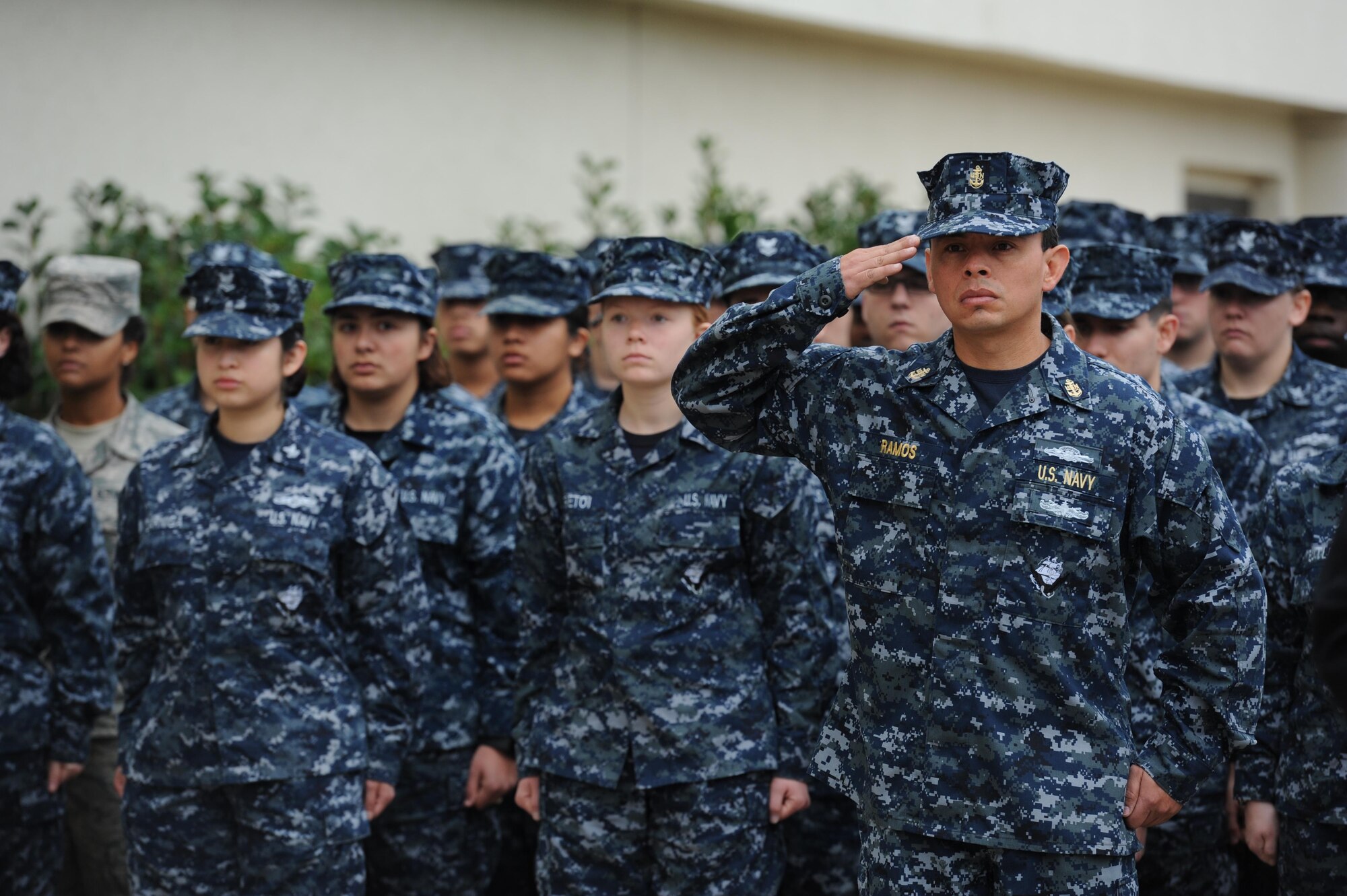 U.S. Navy Chief Petty Officer Michael Ramos, Center for Naval Aviation Technical Training Unit Keesler instructor, renders a salute during the singing of the national anthem at a CNATTU Keesler Pearl Harbor 75th Anniversary Remembrance Ceremony in front of Allee Hall Dec. 7, 2016, on Keesler Air Force Base, Miss. More than 100 Keesler personnel attended the event to honor those lost in the Dec. 7, 1941 Pearl Harbor attacks. (U.S. Air Force photo by Kemberly Groue)