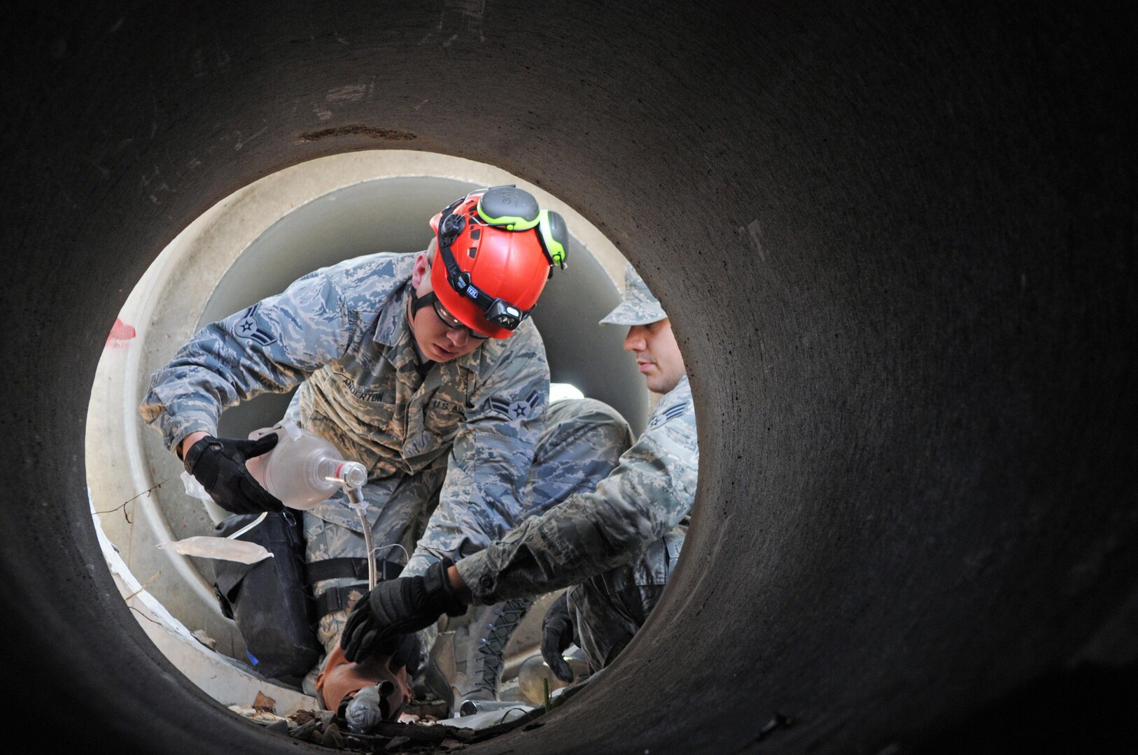 Airman 1st Class Brooks Anderton, an aerospace medical technician assigned to the 151st Chemical, Biological, Radiological, Nuclear (CBRN) Enhanced Response Force Package (CERFP) treats a simulated casualty inside a tunnel during search and recovery training on April 24, 2016, at the Davis County Unified Fire rubble pile in Layton, Utah.
