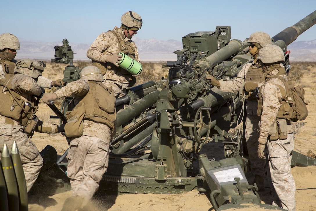 Marines with Battery K, 3rd Battalion, 11th Marine Regiment, prepare an M777A2 Howitzer to fire in the Acorn Training Area aboard the Marine Corps Air Ground Combat Center, Twentynine Palms, Calif., Dec. 2, 2016, during the regiment’s “Top Gun” competition. (Official Marine Corps photo by Cpl. Levi Schultz/Released)