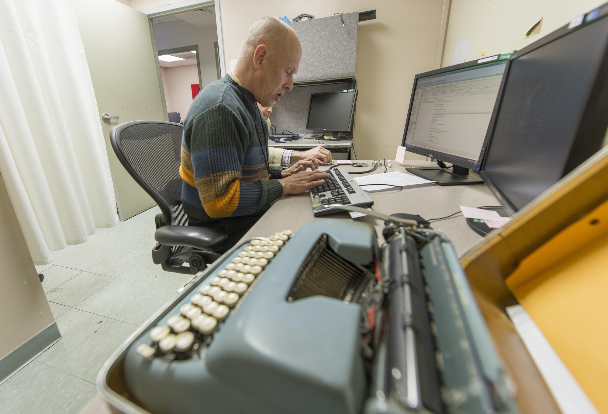 Retired Col. Pete Mapes, a pilot-physician, still uses a typewriter when he sees patients at the Joint Base Andrews, Md., Flight Medicine Clinic, April 7, 2016. Mapes was instrumental to the employment of the Automatic Ground Collision Avoidance System (Auto GCAS) in fighter jets across the Air Force after he discovered an error in the program data while at the Air Force Research Lab at Wright Patterson AFB, Ohio in 2003. The system, which constantly compares the aircraft's speed and position to a digital terrain map and will automatically take control if it detects an imminent ground collision, is credited with saving the lives of four pilots. (U.S. Air Force photo/Master Sgt. Brian Ferguson)