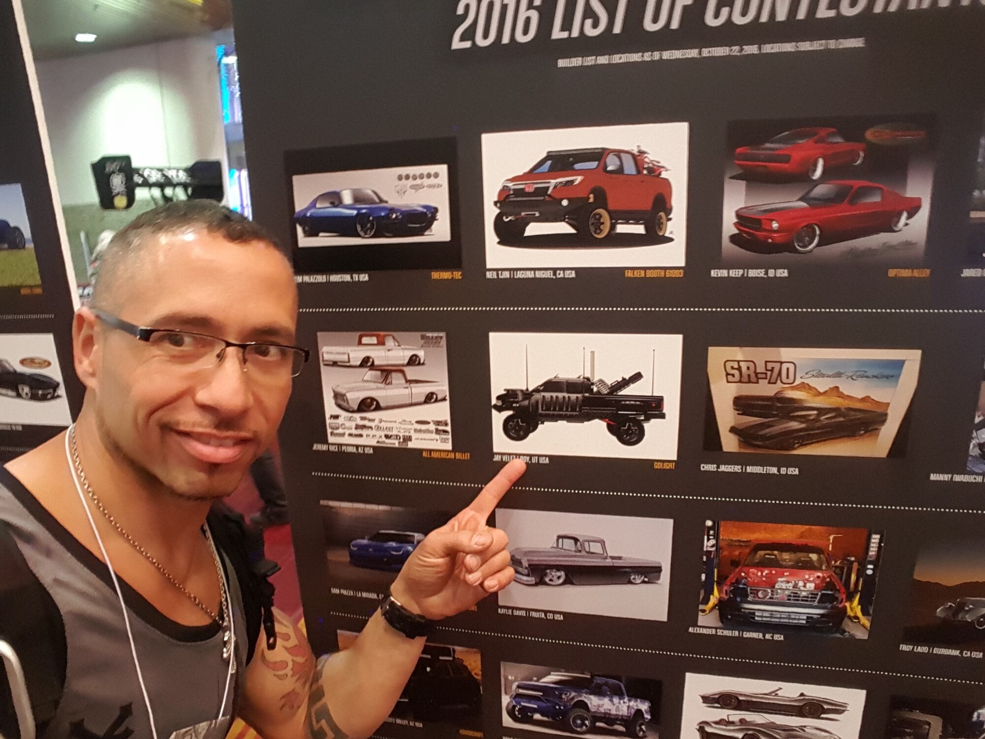 Jason Velez points to a picture of his custom built Dodge Ram 2500. Velez, a retired Airman,  rebuilt the truck to resemble a vehicle halfway between a personal vehicle and tactical military vehicle. Velez's truck was on exhibit in the Battle of the Builder at the 2016 Specialty Equipment Market Association (SEMA) Show in Las Vegas in November, the foremost automotive specialty products trade event worldwide. (Courtesy photo)