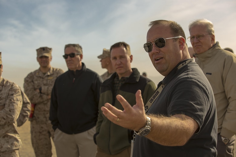 Casey Harsh, requirements analyst, Marine Corps Expeditionary Energy Office, explains different efforts and technologies the Marine Corps has developed during the Energy Capability Exercise, in alignment with the Great Green Fleet initiative, at Camp Wilson aboard the Marine Corps Air Ground Combat Center, Twentynine Palms, Calif., Dec. 6, 2016. (Official Marine Corps photo by Cpl. Levi Schultz/Released)
