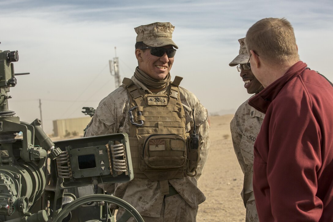 Lance Cpl. Marlon A. Hill, field artillery cannoneer, 3rd Battalion, 11th Marine Regiment, explains different efforts and technologies 3/11 has utilized during the Energy Capability Exercise, in alignment with the Great Green Fleet initiative, at Camp Wilson aboard the Marine Corps Air Ground Combat Center, Twentynine Palms, Calif., Dec. 6, 2016. (Official Marine Corps photo by Cpl. Levi Schultz/Released)