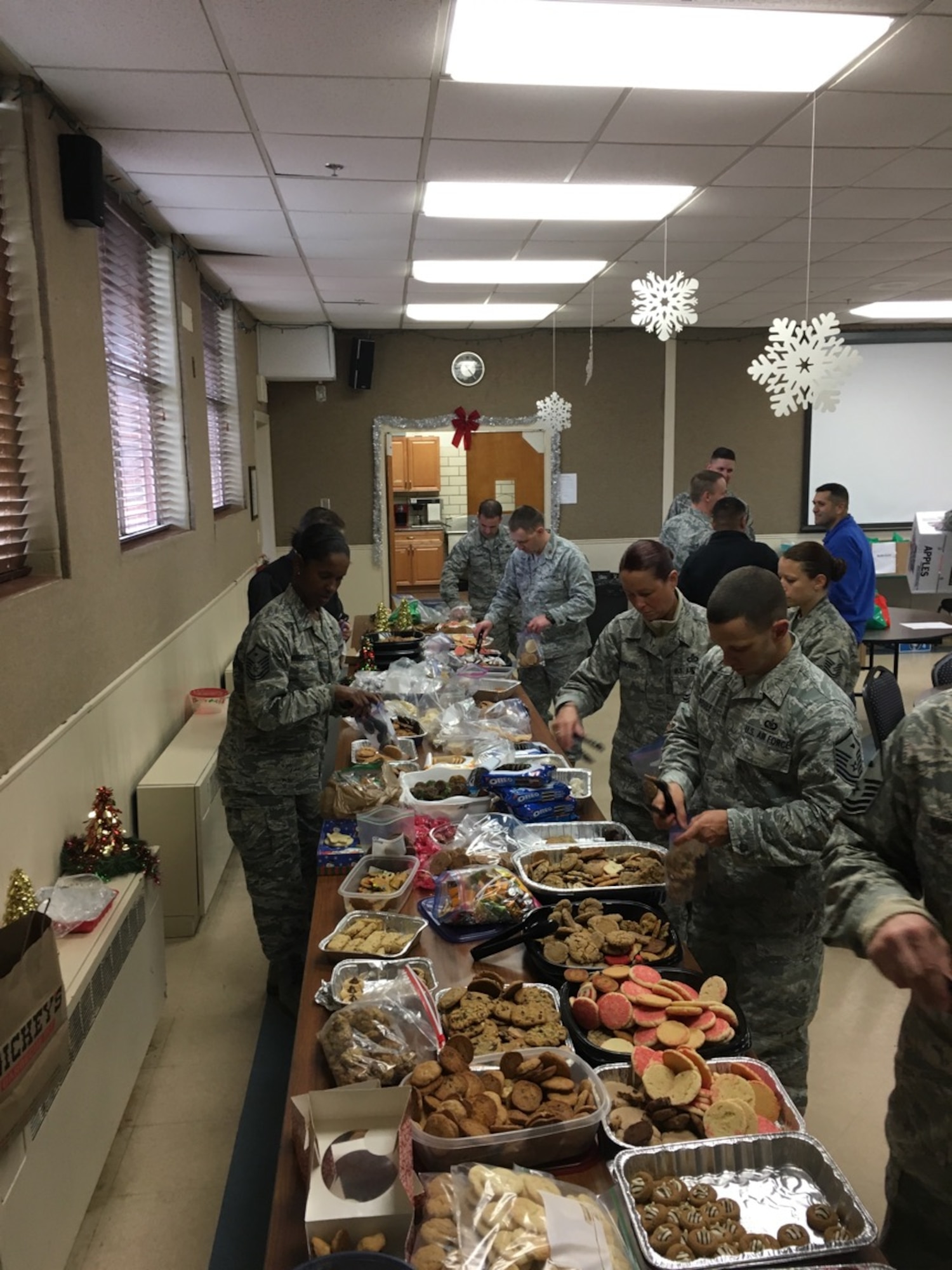 Dyess first sergeants and volunteers organize bags of cookies and other treats as part of Operation Cookie Drop at Dyess Air Force Base, Texas, Dec. 8, 2016. Dyess leadership, spouses and various organizations from the Abilene community donated more than 7,000 cookies and other treats that were given out to dorm residents. (Courtesy photo)