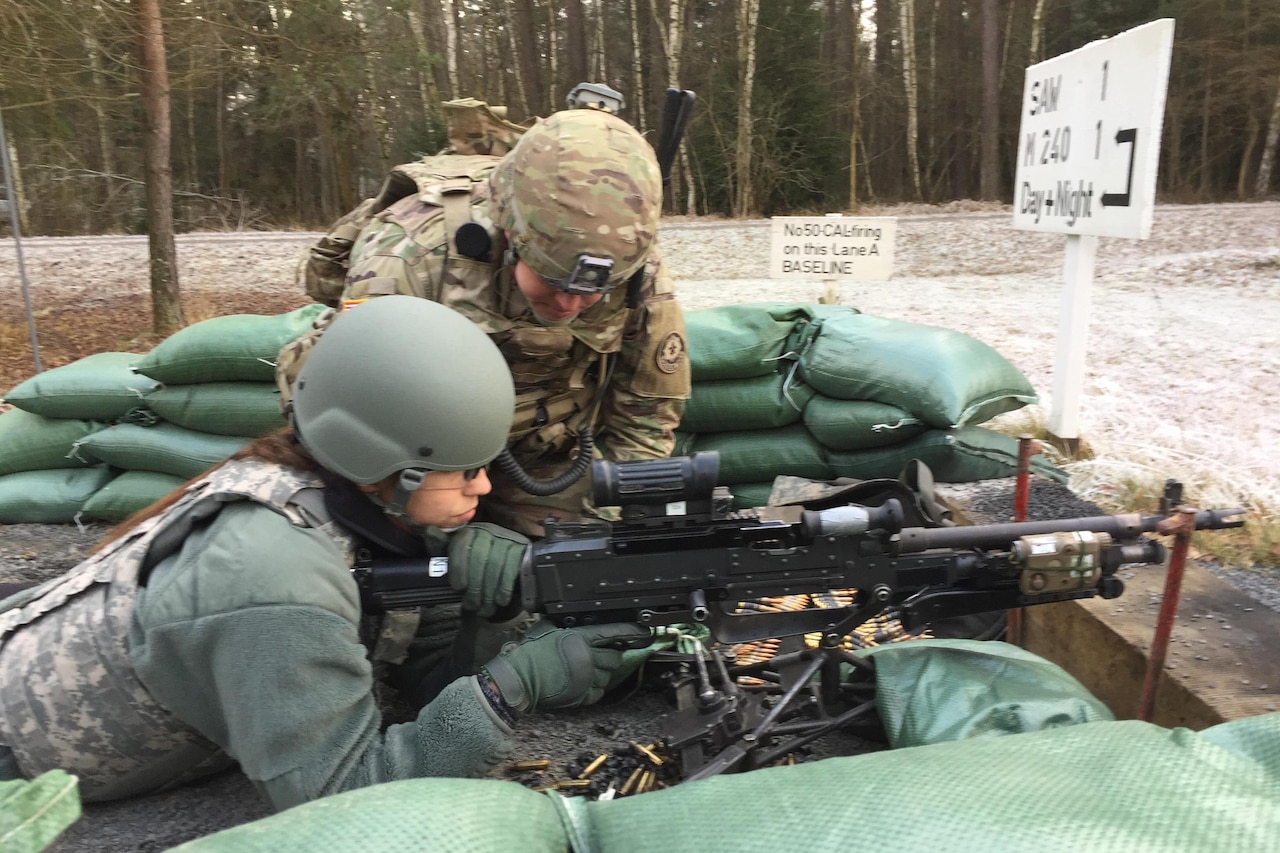 Olympic Gold Medalist Maya DiRado fires an M240 machine gun at a range at Grafenwoehr, Germany, Dec. 8, 2016. The swimmer is part of a USO tour to the Middle East and Europe. DoD photo by Jim Garamone