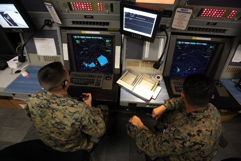 Sgt. Aaron Mondloch, left, receives guidance from Sgt. Benjamin Bonilla while communicating with an aircraft at Marine Corps Air Station Cherry Point, N.C., Nov. 16, 2016.Bonilla has successfully completed all the training required as an approach controller and moved on to completing certifications for the other sections of air traffic control within the Marine Corps.  Air traffic controllers are given approximately 12 years to become proficient and certified in all ATC elements, but Bonilla has completed his training in only four years while aboard the air station. Mondloch is an air traffic controller and Bonilla is an approach controller and, both assigned to Marine Air Control Squadron 2, Marine Air Control Group 28, 2nd Marine Aircraft Wing. (U.S. Marine Corps photo by Sgt. N.W. Huertas/ Released)