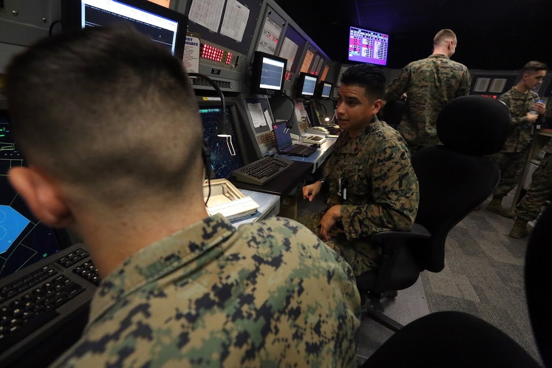 Sgt. Benjamin Bonilla instructs a student on procedures when communicating with an aircraft at Marine Corps Air Station Cherry Point, N.C., Nov. 16, 2016.Bonilla has successfully completed all the training required as an approach controller and moved on to completing certifications for other sections of air traffic control within the Marine Corps.  Air traffic controllers are given approximately 12 years to become proficient and certified in all ATC elements, but Bonilla has completed his training in only four years while aboard the air station. Bonilla is an approach controller assigned to Marine Air Control Squadron 2, Marine Air Control Group 28, 2nd Marine Aircraft Wing. (U.S. Marine Corps photo by Sgt. N.W. Huertas/ Released)
