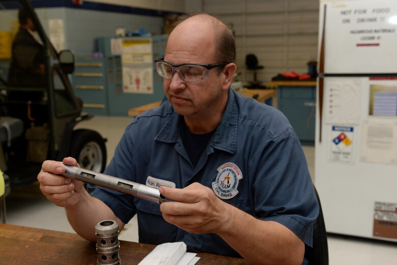 Ronald Roman, 97th Maintenance Directorate hydraulics mechanic, works on a U.S. Air Force KC-135 Stratotanker selector valve, Nov. 11, 2016, Altus Air Force Base, Oklahoma. The valve is used to direct hydraulic fluid under pressure to raise or lower landing gear for takeoff and landing. (U.S. Air Force Photo by Airman Jackson N. Haddon/Released).
