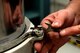 Brian Trigg, 97th Maintenance Directorate hydraulic mechanic, removes a bolt from a U.S. Air Force C-17 Globemaster III main landing gear shock strut, Nov. 11, 2016, Altus Air Force Base, Oklahoma. The shock strut cushions the aircraft landing by metering fluid levels from one chamber to the other. (U.S. Air Force Photo by Airman Jackson N. Haddon/Released).