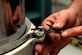 Brian Trigg, 97th Maintenance Directorate hydraulic mechanic, removes a bolt from a U.S. Air Force C-17 Globemaster III main landing gear shock strut, Nov. 11, 2016, Altus Air Force Base, Oklahoma. The shock strut cushions the aircraft landing by metering fluid levels from one chamber to the other. (U.S. Air Force Photo by Airman Jackson N. Haddon/Released).