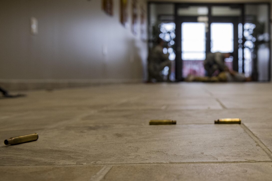 Bullet casings rest on the floor as members of the 23d Security Forces Squadron detain the simulated active shooter, Staff Sgt. Christopher Childress, 23d SFS military working dog trainer, during an active shooter exercise, Dec. 8, 2016, at Moody Air Force Base, Ga. This exercise caused included securing entrances to nearly every building on base. (U.S. Air Force photo by Airman 1st Class Daniel Snider)