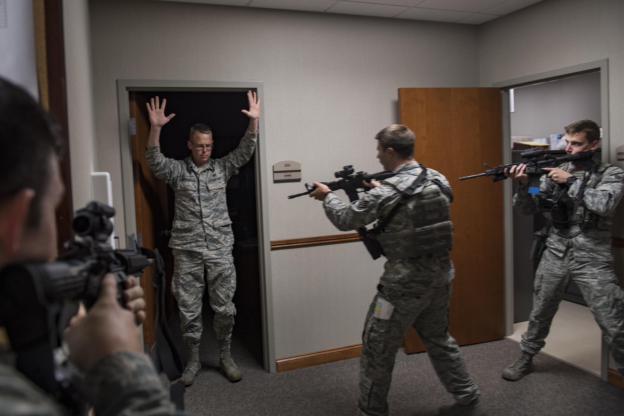 Members of the 23d Security Forces Squadron approach Capt. Bradley Richardson, 23d Wing assistant judge advocate, to ensure he’s not a threat, during an active shooter exercise, Dec. 8, 2016, at Moody Air Force Base, Ga. Everyone in the building followed the directions ‘run, hide, fight,’ a technique taught for active shooter scenarios. (U.S. Air Force photo by Airman 1st Class Daniel Snider)